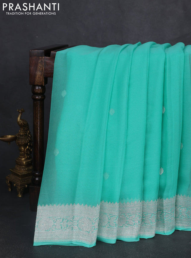 Banarasi chiffon saree teal green shade with silver zari woven buttas and floral silver zari woven border
