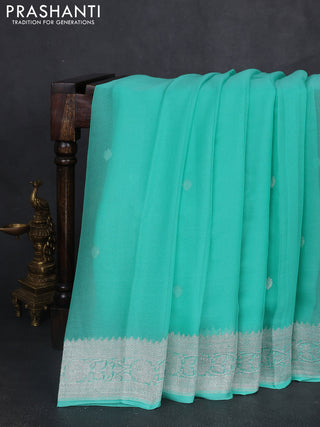 Banarasi chiffon saree teal green shade with silver zari woven buttas and floral silver zari woven border