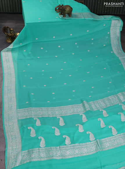 Banarasi chiffon saree teal green shade with silver zari woven buttas and floral silver zari woven border