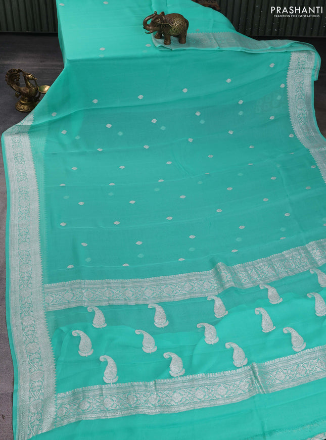 Banarasi chiffon saree teal green shade with silver zari woven buttas and floral silver zari woven border