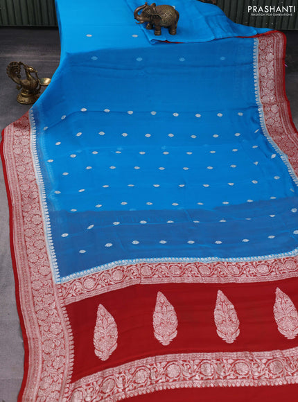 Banarasi chiffon saree cs blue and rust shade with silver zari woven buttas and floral silver zari woven border