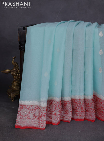 Banarasi chiffon saree mild teal blue and orange with silver zari woven buttas and floral silver zari woven border
