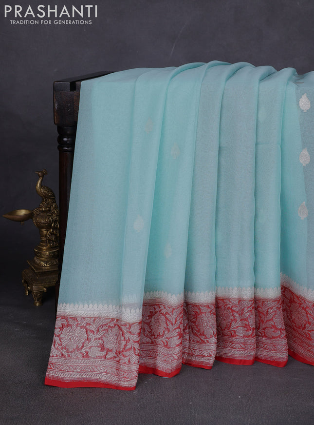 Banarasi chiffon saree mild teal blue and orange with silver zari woven buttas and floral silver zari woven border