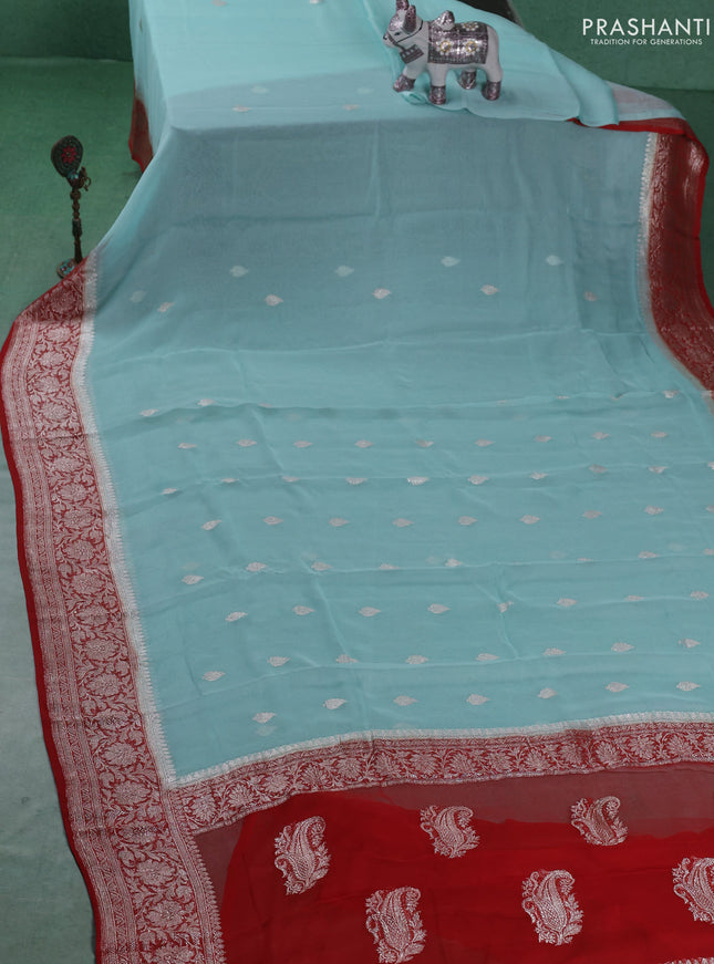 Banarasi chiffon saree mild teal blue and orange with silver zari woven buttas and floral silver zari woven border