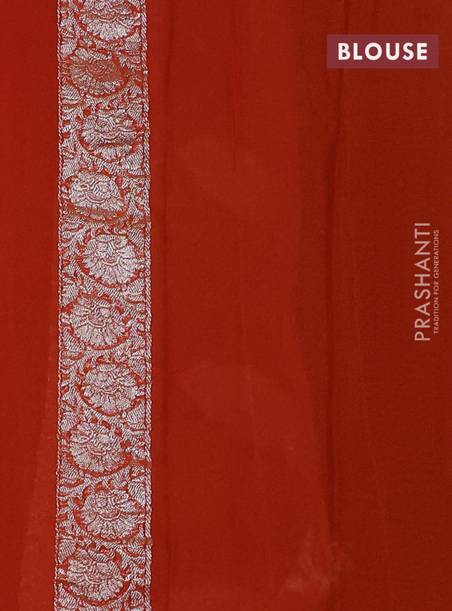 Banarasi chiffon saree black and orange with silver zari woven buttas and floral silver zari woven border