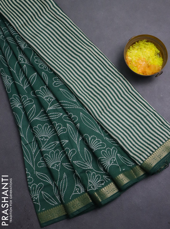Muslin silk saree dark green with allover floral prints and zari woven border