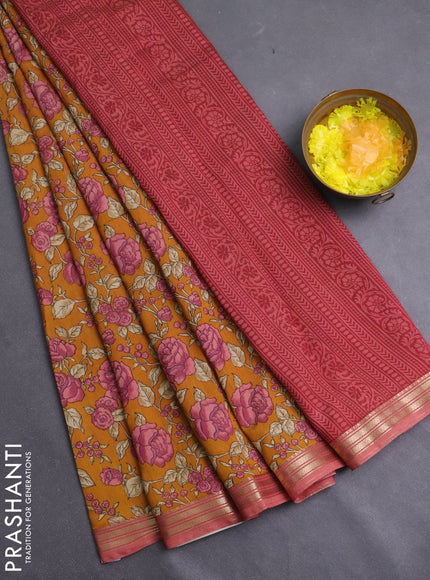 Muslin silk saree dark mustard and peach shade with allover floral prints and zari woven border