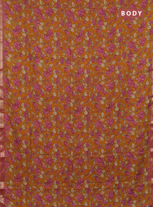 Muslin silk saree dark mustard and peach shade with allover floral prints and zari woven border