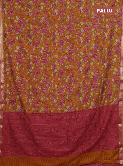 Muslin silk saree dark mustard and peach shade with allover floral prints and zari woven border