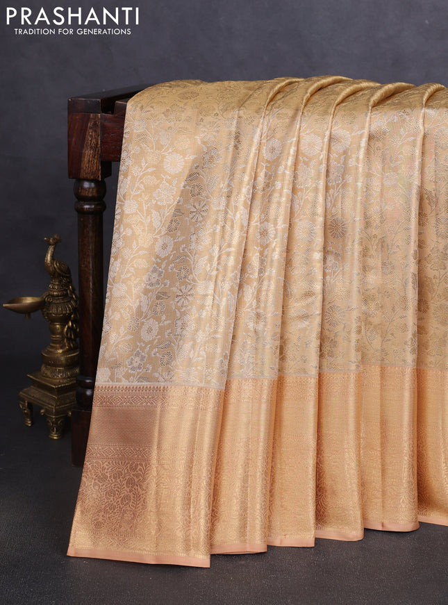 Pure kanchipuram tissue silk saree sandal and pastel peach with allover floral zari woven brocade weaves and zari woven border