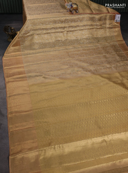 Pure kanchipuram tissue silk saree sandal and pastel peach with allover floral zari woven brocade weaves and zari woven border