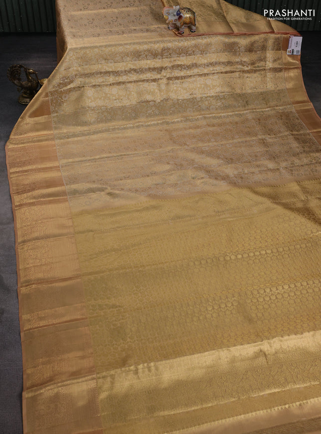 Pure kanchipuram tissue silk saree sandal and pastel peach with allover floral zari woven brocade weaves and zari woven border