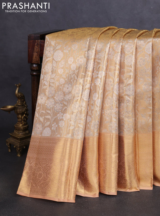 Pure kanchipuram tissue silk saree mild peach shade with allover floral zari woven brocade weaves and zari woven border