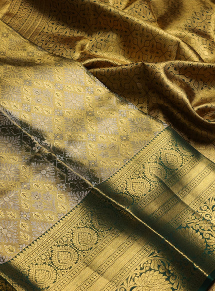 Pure kanchipuram tissue silk saree gold and bottle green with allover zari woven brocade weaves and long rich zari woven floral border