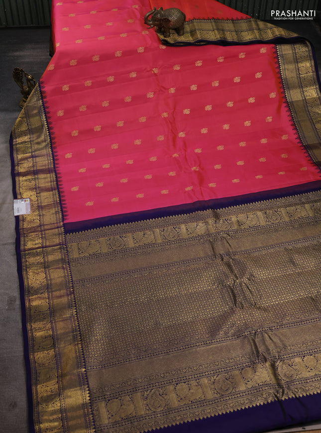 Pure gadwal silk saree dual shade of peach pink and navy blue with annam zari woven buttas and temple design zari woven border
