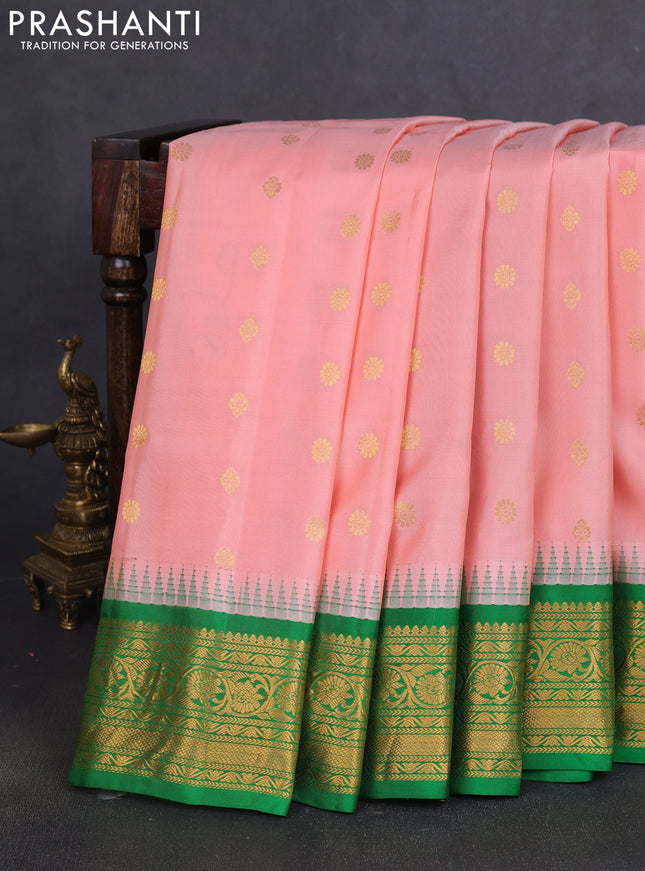 Pure gadwal silk saree mild peach and green with zari woven buttas and temple design zari woven border