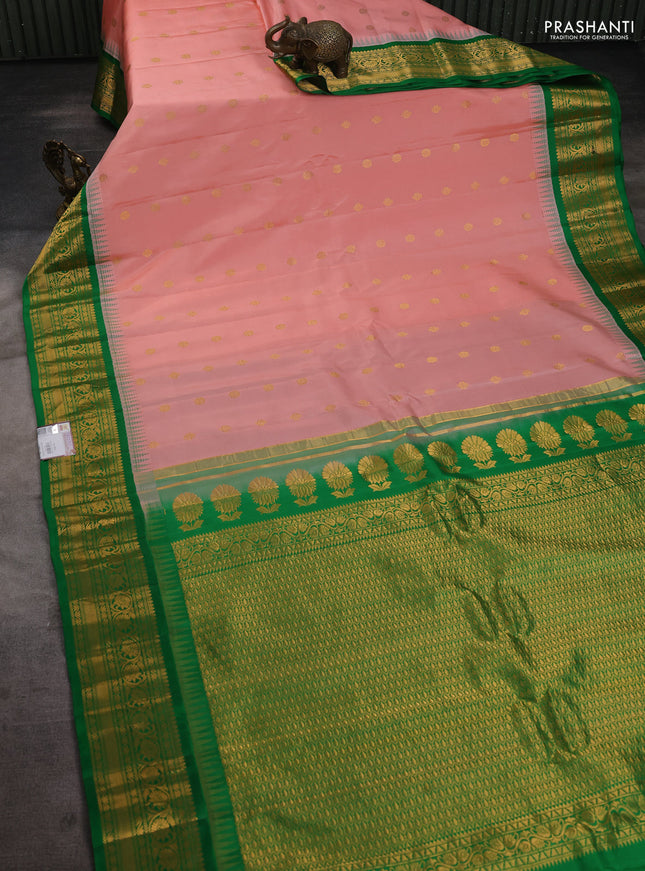 Pure gadwal silk saree mild peach and green with zari woven buttas and temple design zari woven border