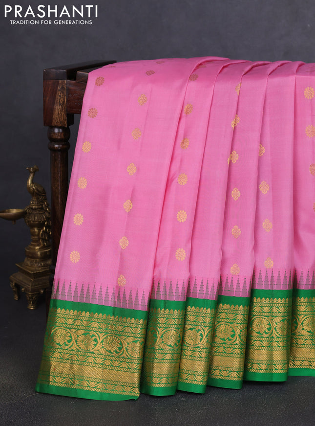 Pure gadwal silk saree light pink and green with allover zari woven buttas and temple design zari woven border