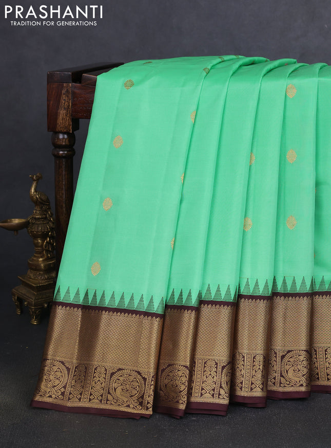Pure gadwal silk saree teal green shade and coffee brown with zari woven buttas and temple design zari woven border