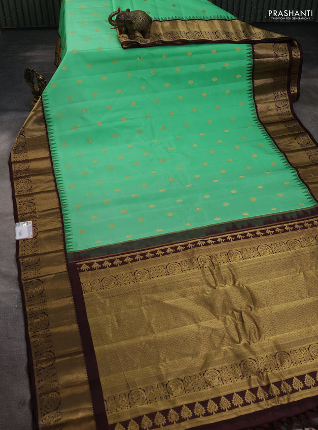Pure gadwal silk saree teal green shade and coffee brown with zari woven buttas and temple design zari woven border
