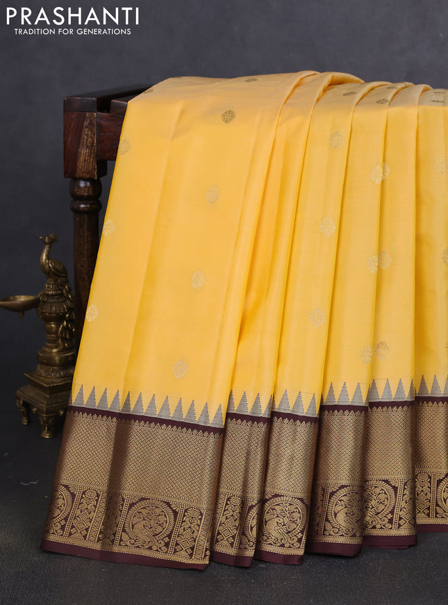 Pure gadwal silk saree yellow shade and coffee brown with zari woven buttas and temple design zari woven border