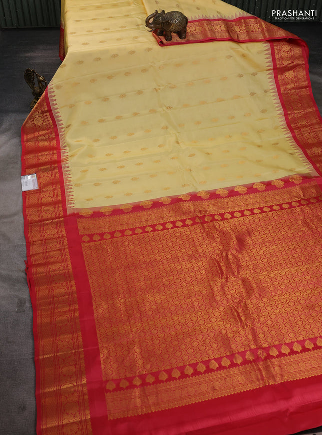 Pure gadwal silk saree pale yellow and red with zari woven buttas and temple design zari woven border