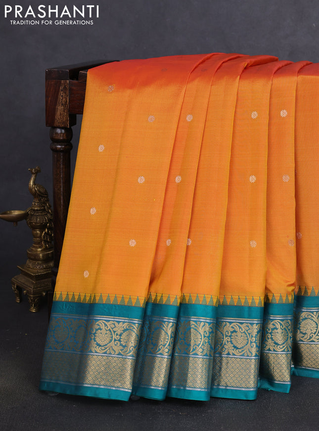 Pure gadwal silk saree dual shade of mustard yellowish pink and teal green with zari woven buttas and temple design zari woven korvai border