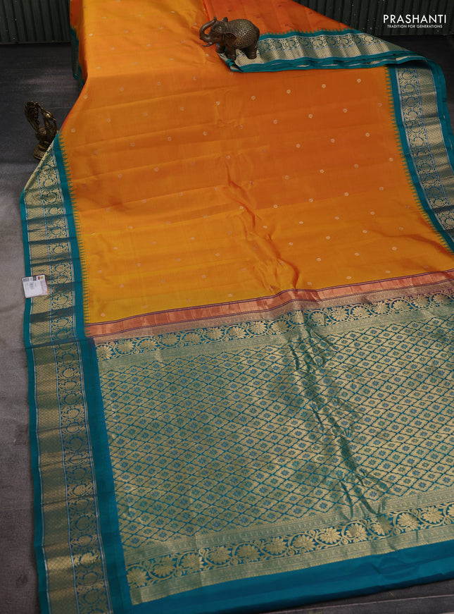 Pure gadwal silk saree dual shade of mustard yellowish pink and teal green with zari woven buttas and temple design zari woven korvai border
