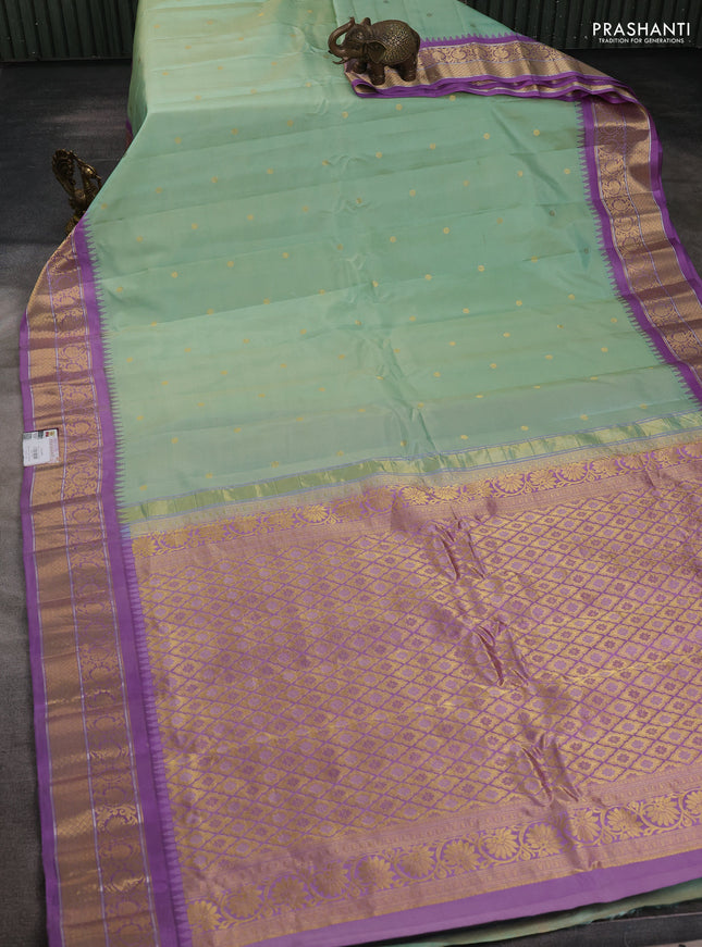 Pure gadwal silk saree pastel green and lavender with zari woven buttas and temple design zari woven korvai border