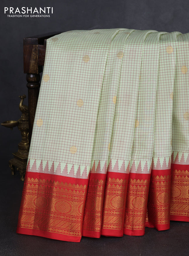 Pure gadwal silk saree mild pista green and orange with allover checks & zari buttas and temple design zari woven border