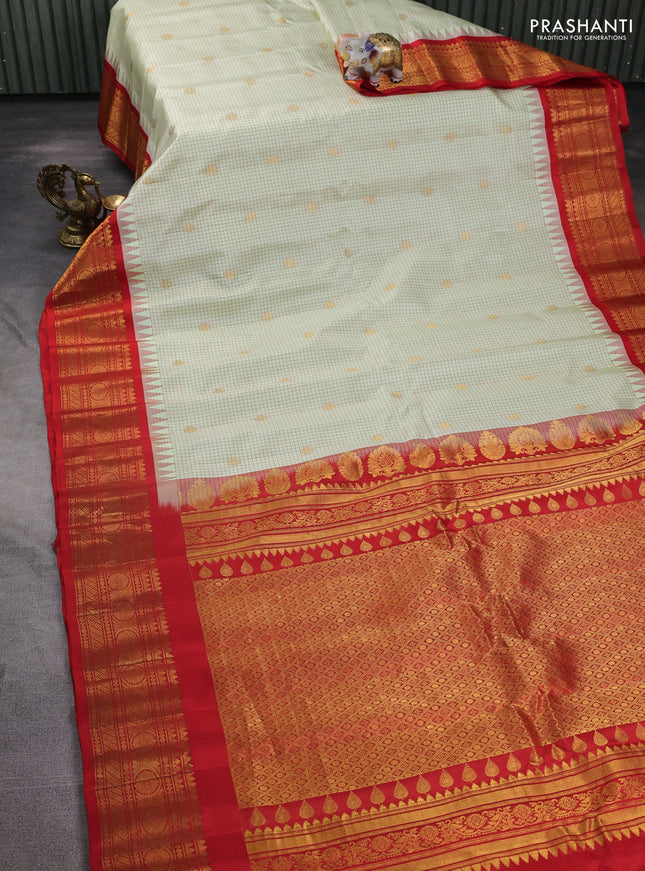 Pure gadwal silk saree mild pista green and orange with allover checks & zari buttas and temple design zari woven border