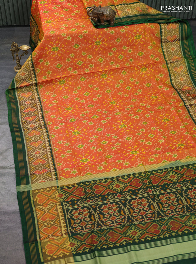 Rajkot patola silk saree dual shade of sunset orange and bottle green with allover ikat weaves and long ikat woven border