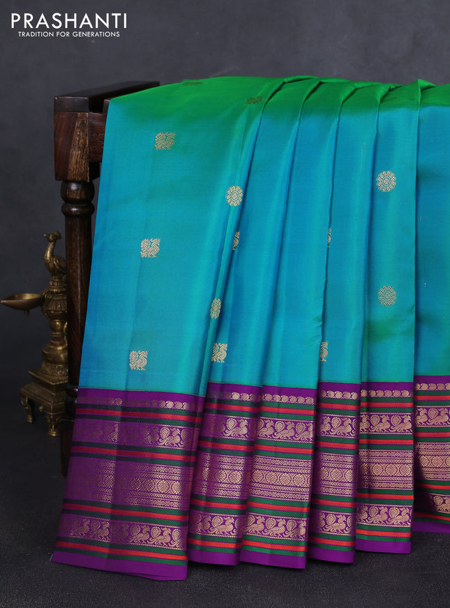 Pure kanchipuram silk saree dual shade of teal bluish green and purple with zari woven buttas and rich zari woven korvai border