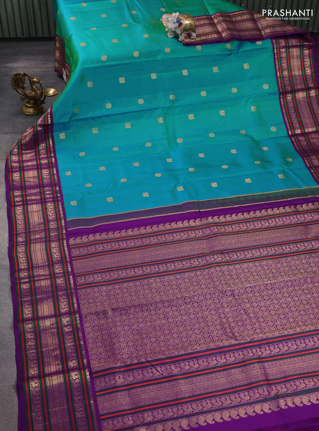 Pure kanchipuram silk saree dual shade of teal bluish green and purple with zari woven buttas and rich zari woven korvai border