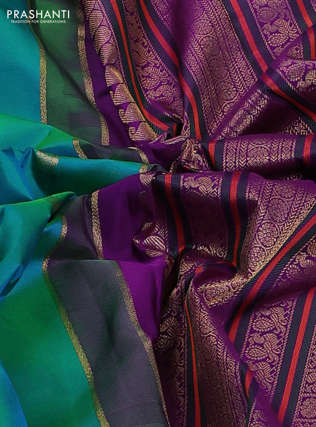 Pure kanchipuram silk saree dual shade of teal bluish green and purple with zari woven buttas and rich zari woven korvai border