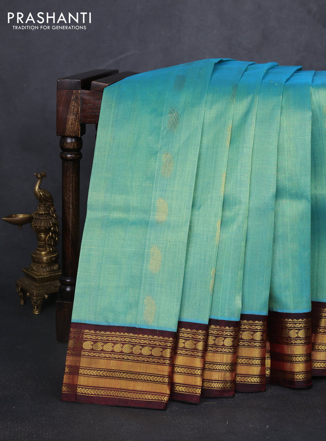 Kuppadam silk cotton saree teal blue and deep maroon with allover paisely zari woven buttas and temple design zari woven border