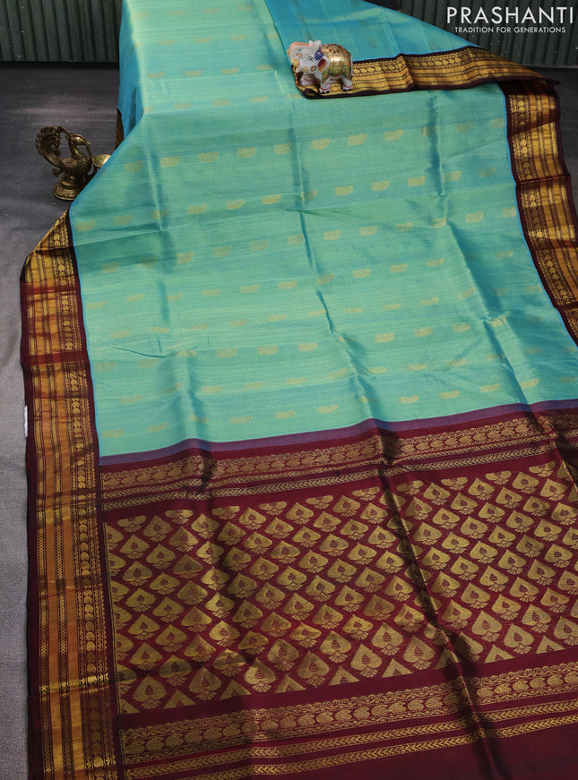 Kuppadam silk cotton saree teal blue and deep maroon with allover paisely zari woven buttas and temple design zari woven border