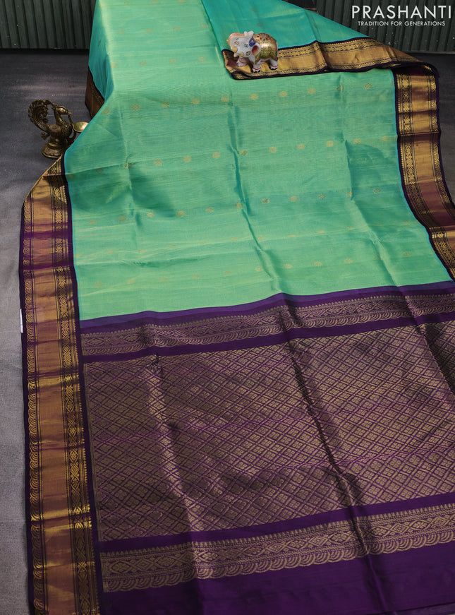 Kuppadam silk cotton saree teal green and purple with plain body and rettapet zari woven border
