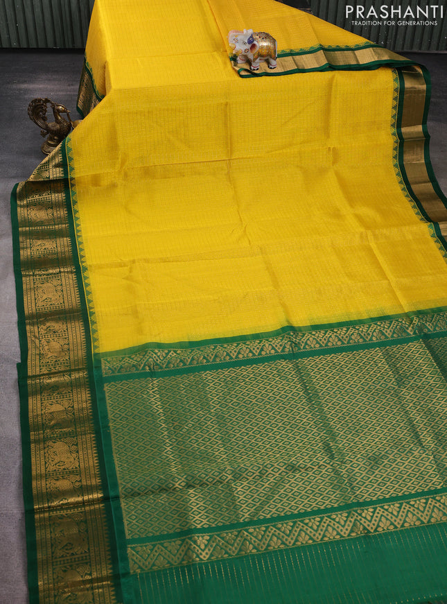 Kuppadam silk cotton saree yellow and green with allover laksha deepam pattern and temple design elephant zari woven border