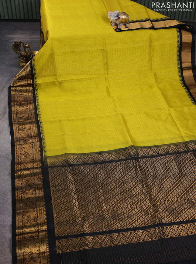 Kuppadam silk cotton saree lime yellow and black with allover laksha deepam pattern and temple design elephant zari woven border