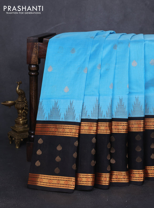Kuppadam silk cotton saree light blue and black with zari woven thilak buttas and long temple design zari woven border