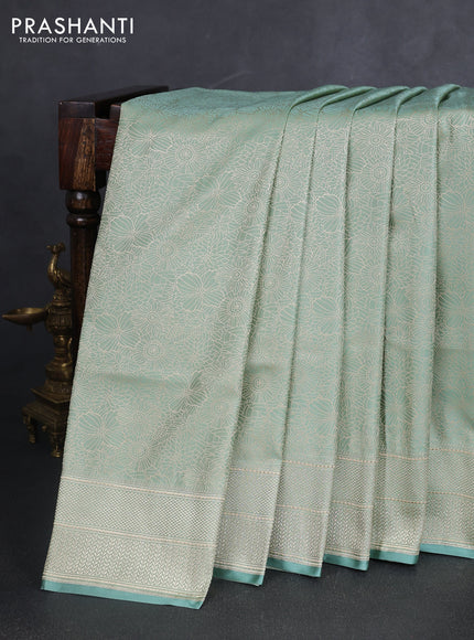 Banarasi semi katan silk saree teal shade with allover floral self emboss and zari woven border