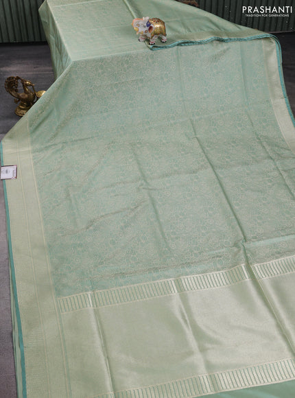 Banarasi semi katan silk saree teal shade with allover floral self emboss and zari woven border