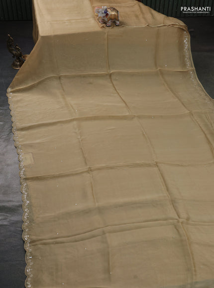 Satin organza silk saree beige and bottle green with mirror embroidery work and ajrakh printed blouse