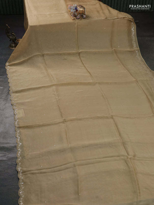 Satin organza silk saree beige and bottle green with mirror embroidery work and ajrakh printed blouse