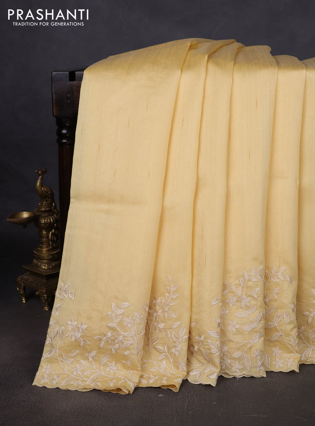 Art tussar saree pale yellow with plain body and floral embroidery border