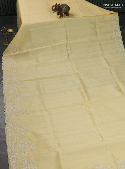 Art tussar saree pale yellow with plain body and floral embroidery border