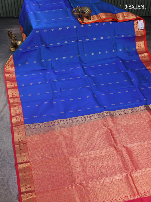 Pure kanchipuram silk saree cs blue and dual shade of pinkish orange with floral zari woven buttas and zari woven korvai border