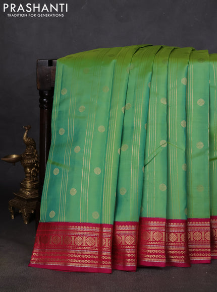 Pure kanchipuram silk saree dual shade of teal green and pink with allover zari stripes & buttas and zari woven korvai border