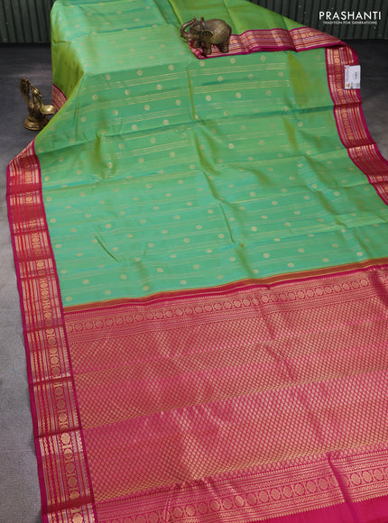 Pure kanchipuram silk saree dual shade of teal green and pink with allover zari stripes & buttas and zari woven korvai border